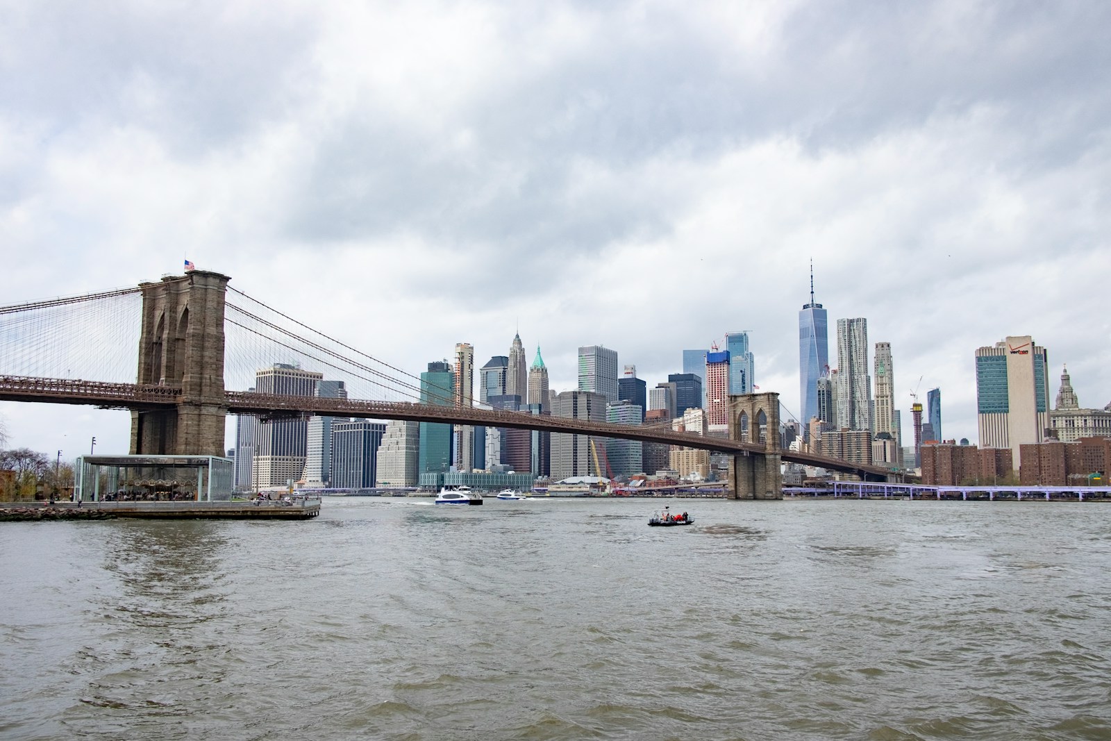 bridge over water under cloudy sky during daytime